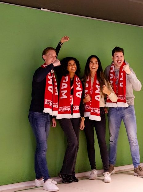 Visitors posing with scarves during Johan Cruijff ArenA VIP Tour.