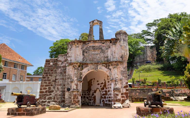 Ancient fortress gate with cannons at A Famosa, Malacca, Malaysia.