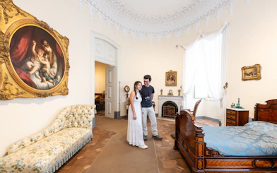 Tourist with guide in the Queen's bedroom of Pena Palace, Sintra, Portugal.