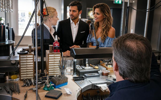 Visitors observing diamond crafting at Royal Coster Diamonds workshop.