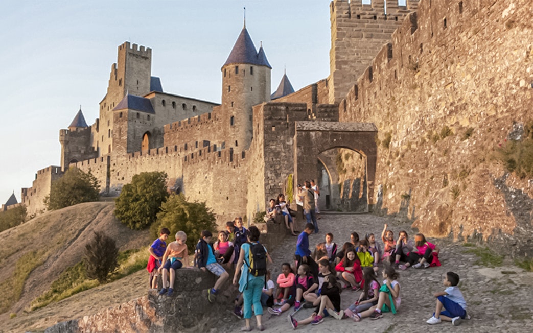 Visitors exploring Carcassonne Castle and Ramparts in France.