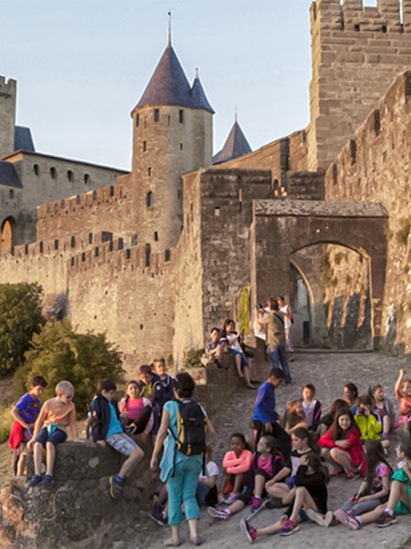 Visitors exploring Carcassonne Castle and Ramparts in France.