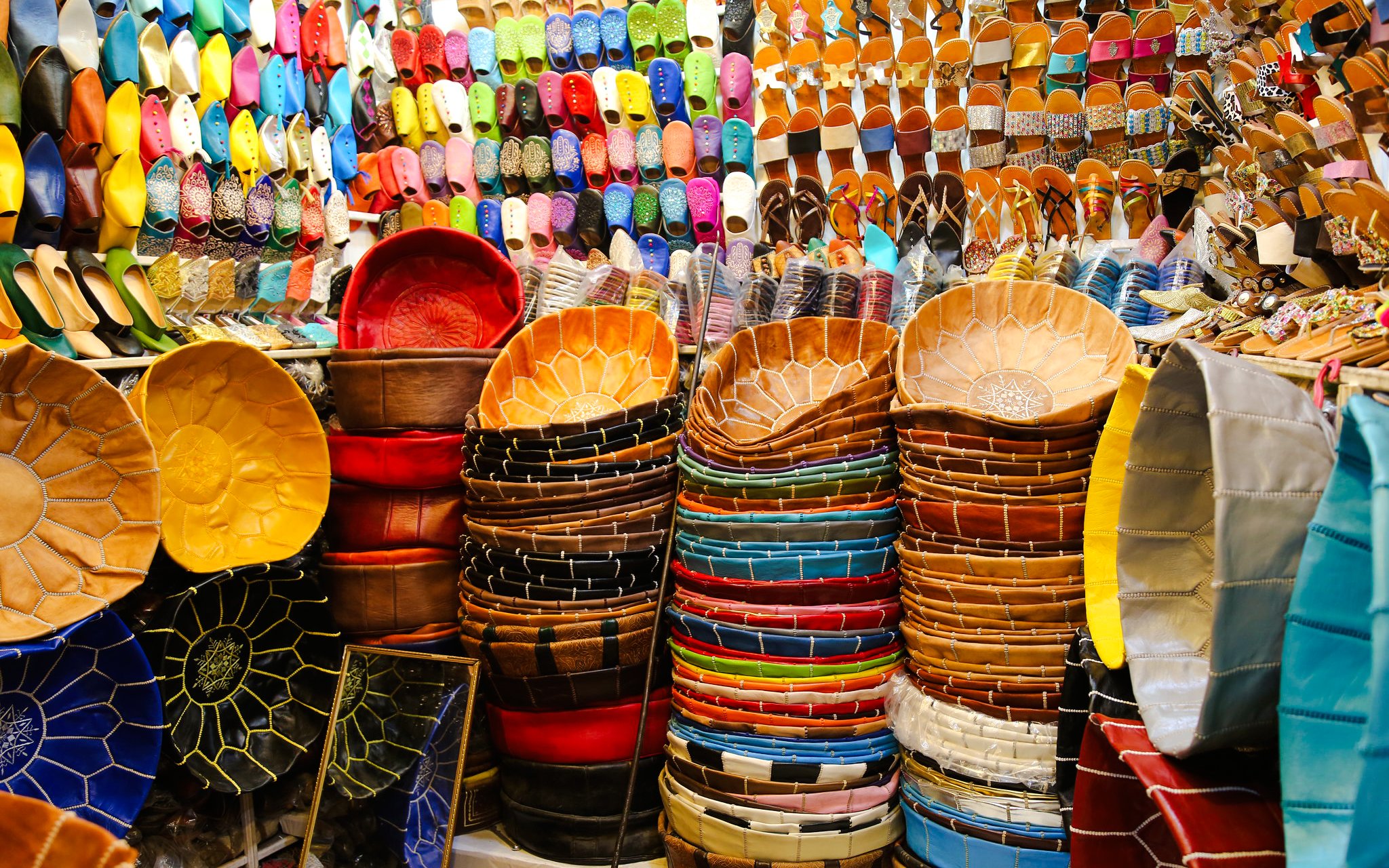 Colorful leather goods and slippers displayed in Marrakech souk.