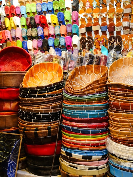 Colorful leather goods and slippers displayed in Marrakech souk.