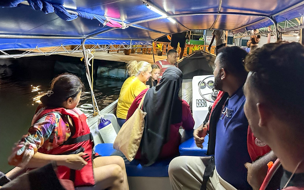 Passengers on a night tour boat during Langkawi mangrove excursion.