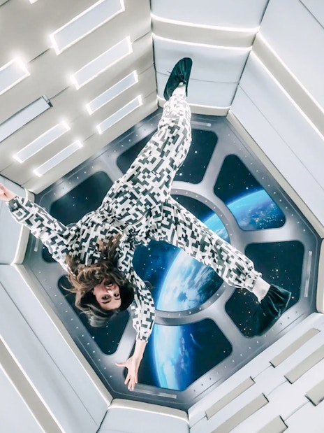 Person floating in Zero Gravity room at Paradox Museum Paris.