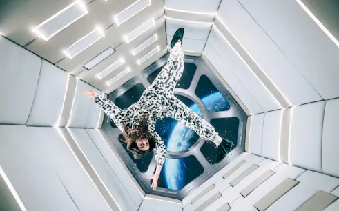 Person floating in Zero Gravity room at Paradox Museum Paris.