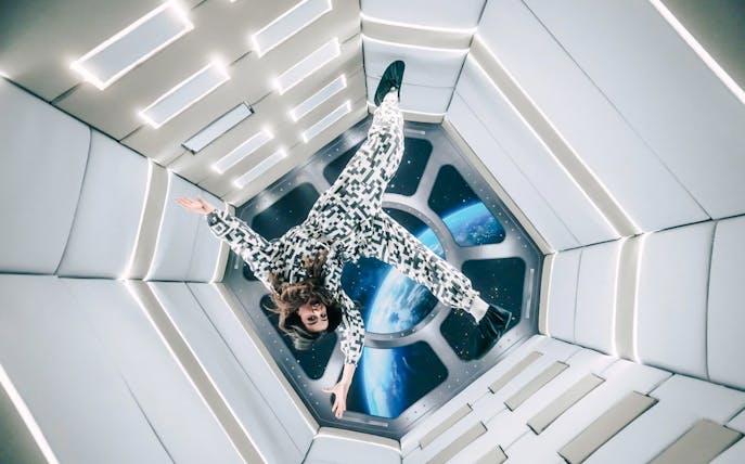 Person floating in Zero Gravity room at Paradox Museum Paris.