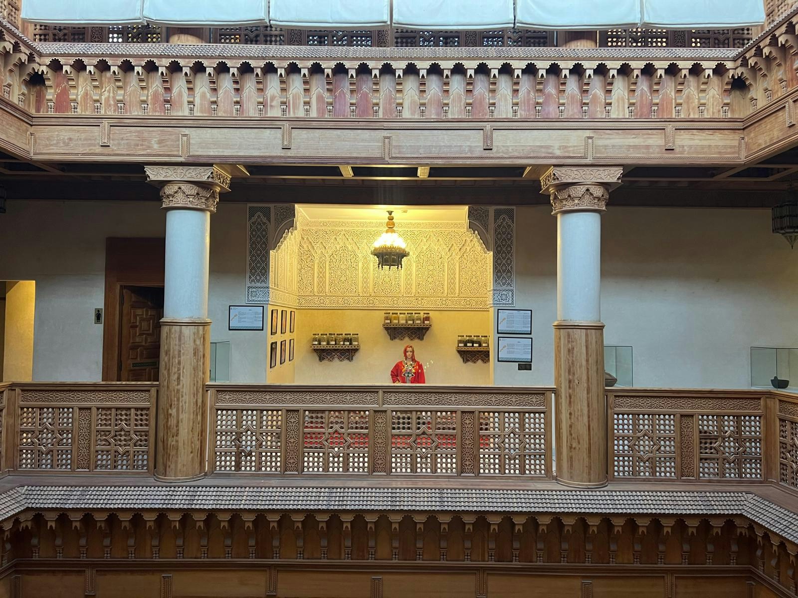 Interior view of Moroccan Culinary Arts Museum with intricate woodwork and decorative columns.