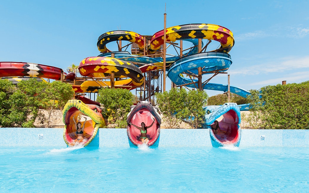 Anaconda water slide at Aqualand El Arenal with colorful snake-themed tubes.