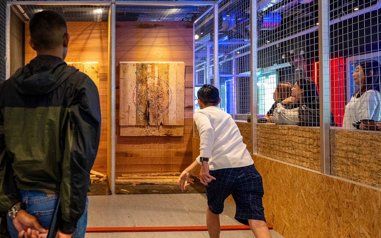 Man throwing axe at target in Axe Factor, Sentosa.