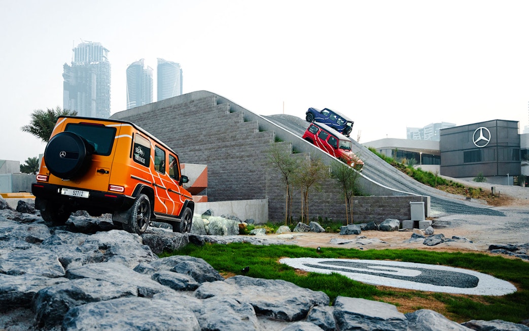 Mercedes-Benz vehicles navigating off-road track in Dubai experience.