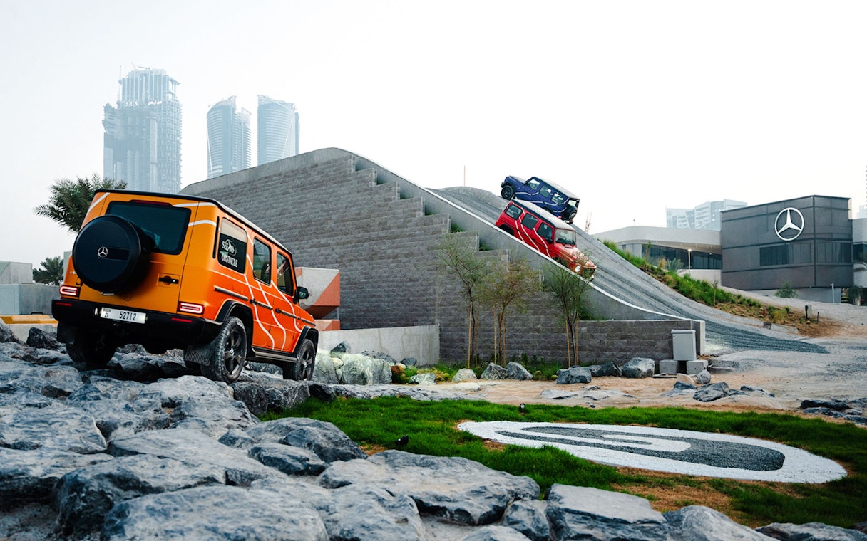 Mercedes-Benz vehicles navigating off-road track in Dubai experience.