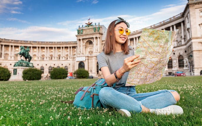 Visitor reading map in front of Hofburg Palace, Vienna, during Skip-the-Line Sisi Museum tour.