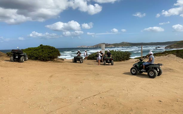 Quad riders exploring coastal trails in Santa Teresa di Gallura with ocean views.