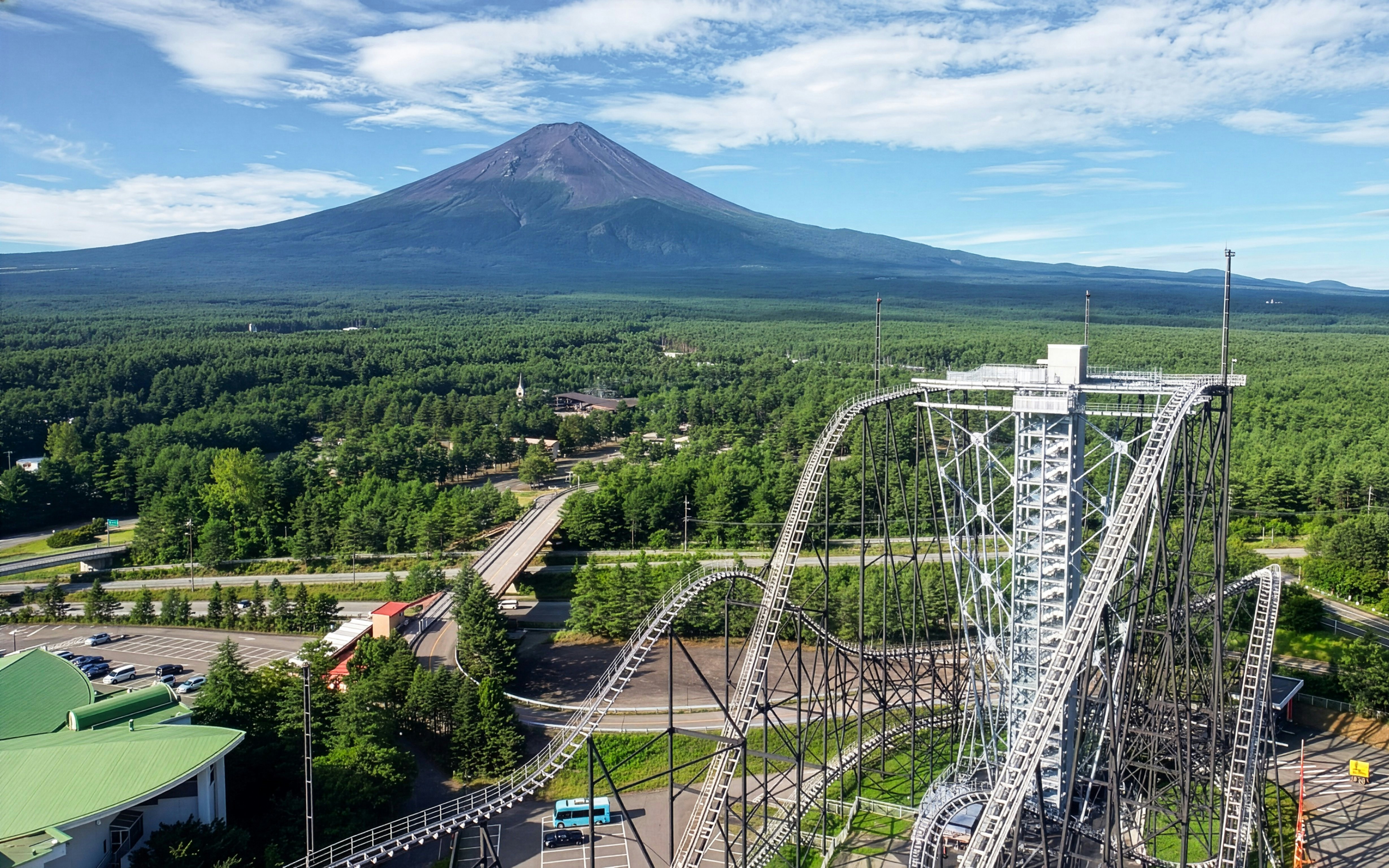 Roller coaster at Fuji-Q Highland Amusement Park with Mount Fuji in the background.
