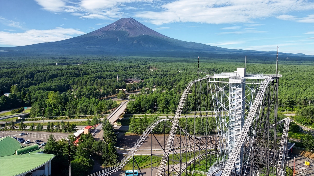 Roller coaster at Fuji-Q Highland Amusement Park with Mount Fuji in the background.