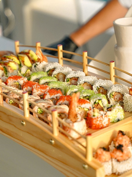 Sushi platter on Sunseeker superyacht with gourmet dining setup.