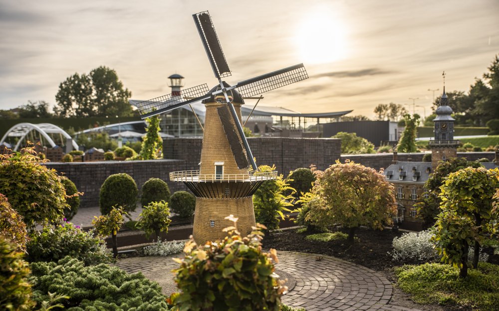 Madurodam miniature windmill and buildings at sunset in The Hague, Netherlands.