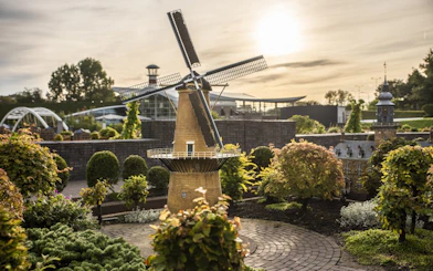 Madurodam miniature windmill and buildings at sunset in The Hague, Netherlands.