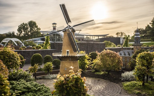 Madurodam miniature windmill and buildings at sunset in The Hague, Netherlands.