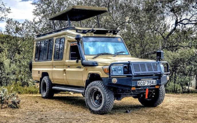 Safari vehicle parked in Nairobi National Park, Kenya.