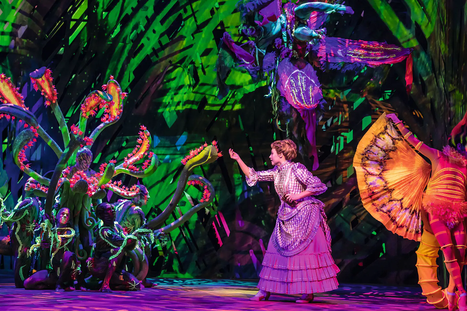 Performer in jungle-themed costume on stage during Disney's Tarzan show.