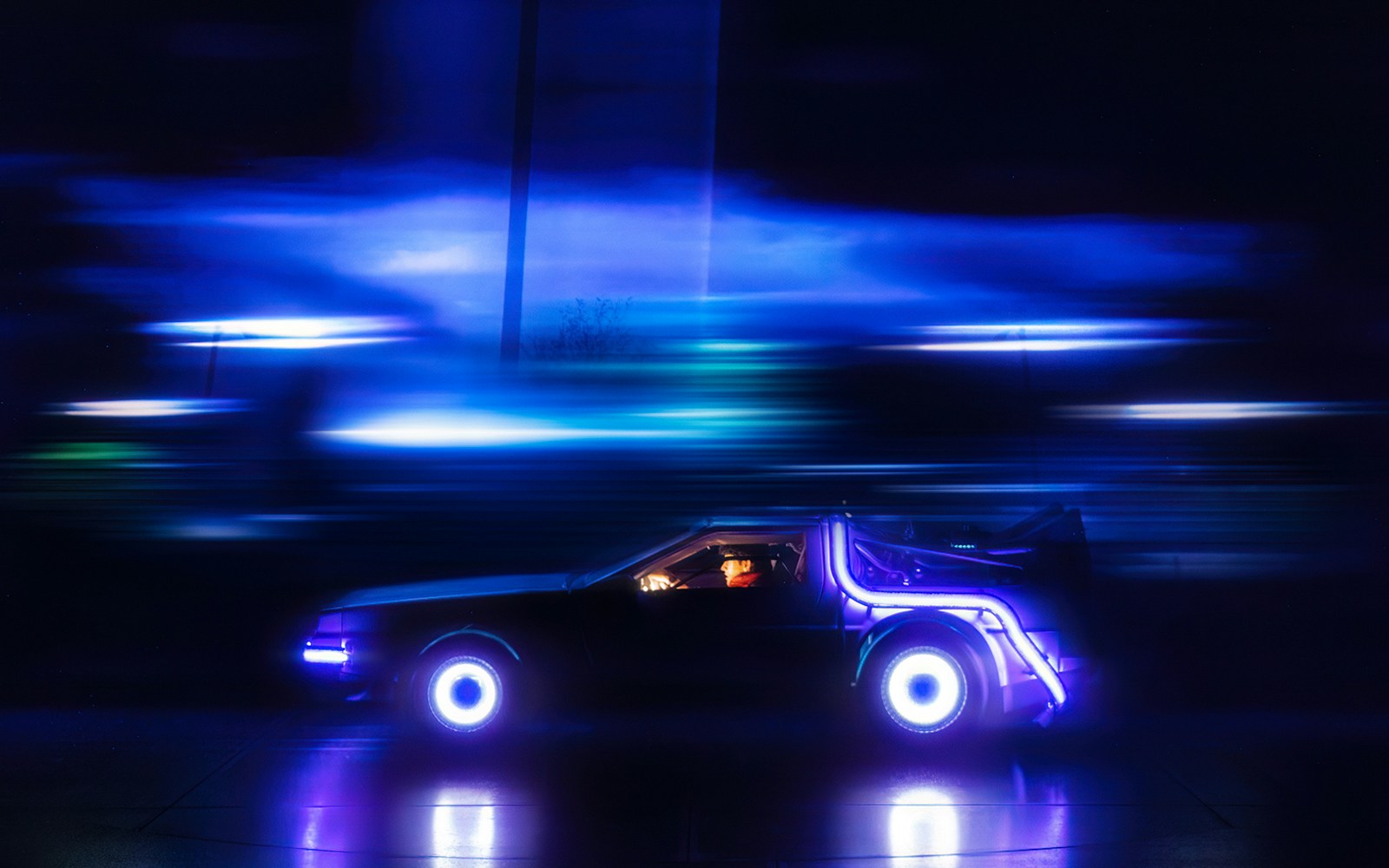 DeLorean car with glowing lights in motion, Back to the Future the Musical.