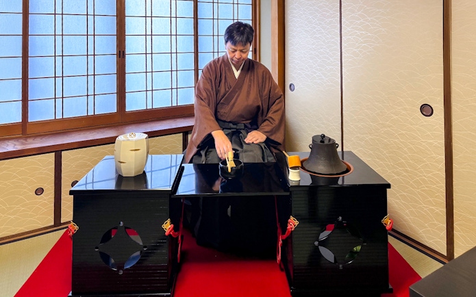 Instructor performing a tea ceremony in a traditional room, Kyoto.