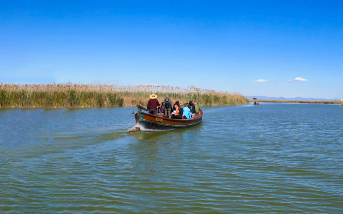 Boat ride through Albufeira Natural Park waterways with passengers enjoying the view.