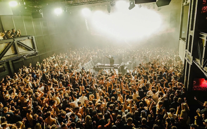 Crowd enjoying Eastenderz performance at a nightclub in Ibiza.