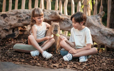 Children feeding a capybara at Bali Zoo.