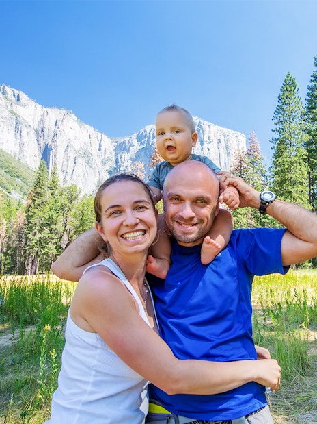 Family with infant enjoying Yosemite National Park, California, with El Capitan in the background.