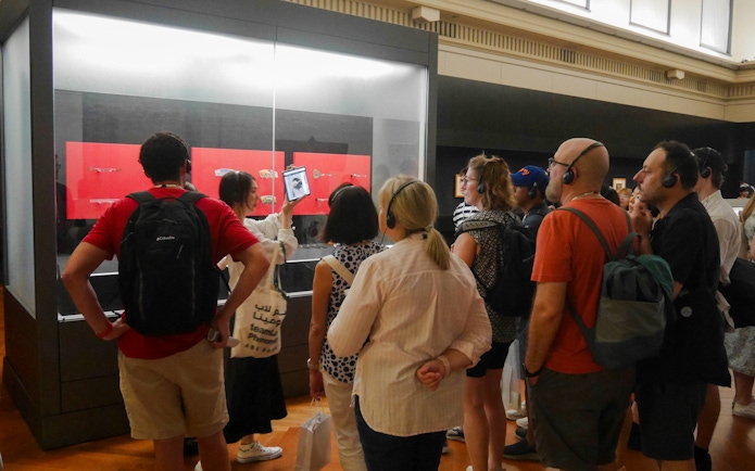 Visitors on a guided tour at Tokyo National Museum viewing exhibits.