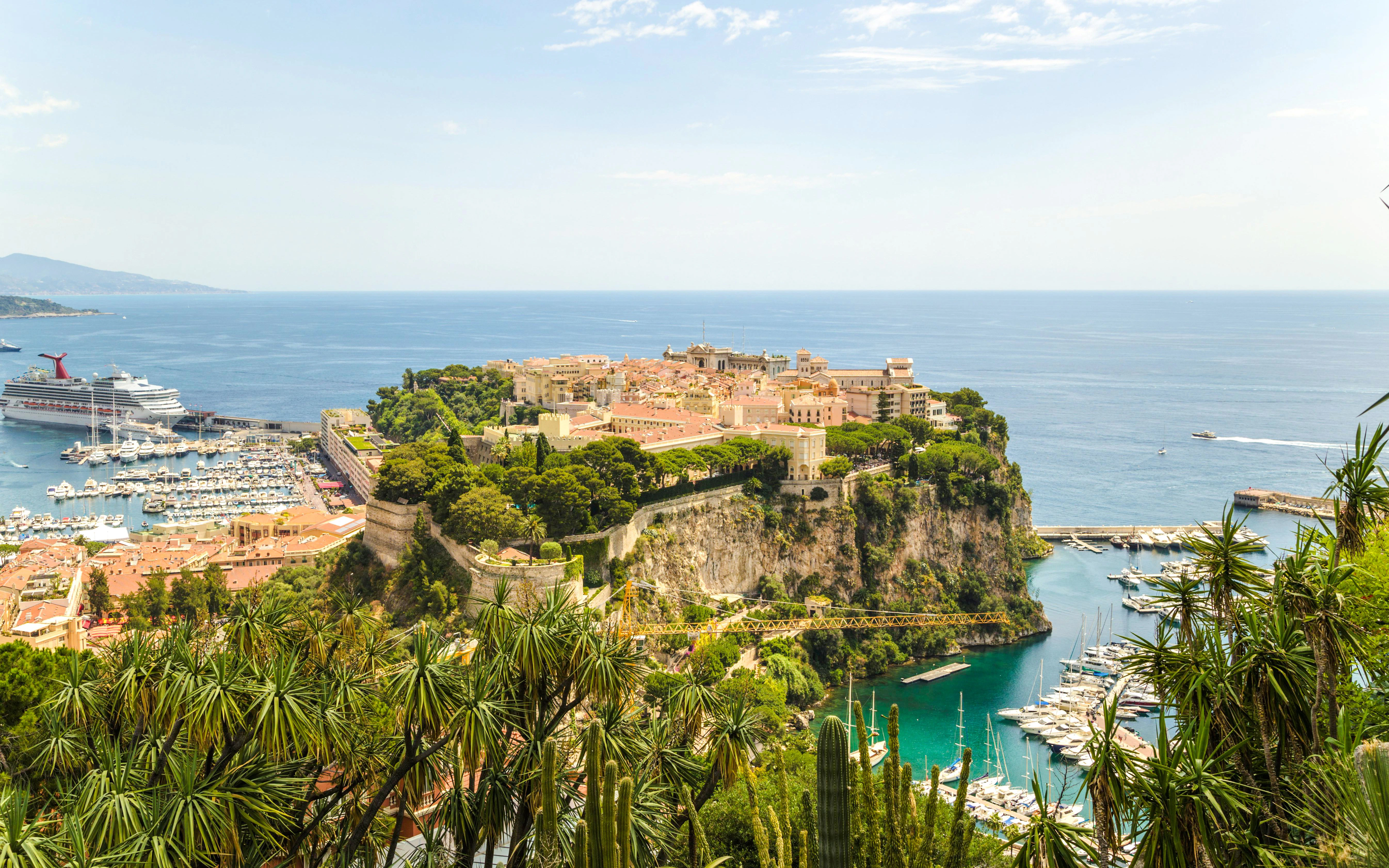 Monaco Ville and harbor view from Rock of Monaco with boats and coastline.