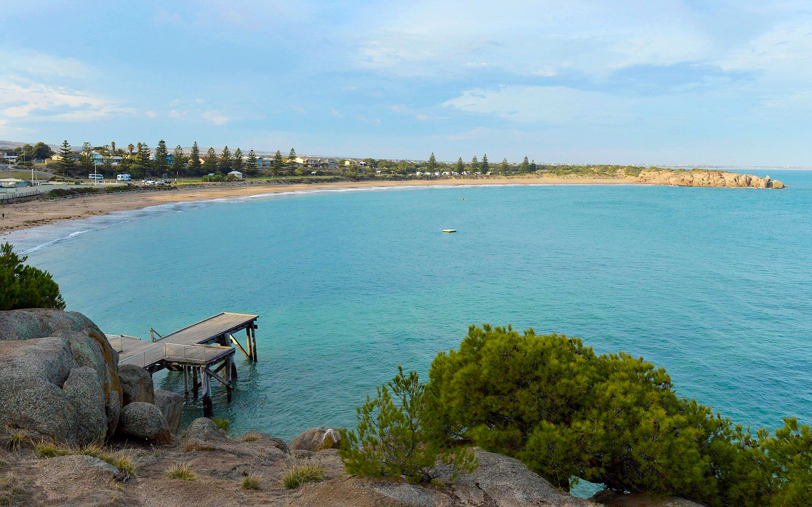 Victor Harbor coastline with a wooden pier and distant beach, Southern Highlights, Australia.