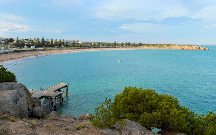 Victor Harbor coastline with a wooden pier and distant beach, Southern Highlights, Australia.