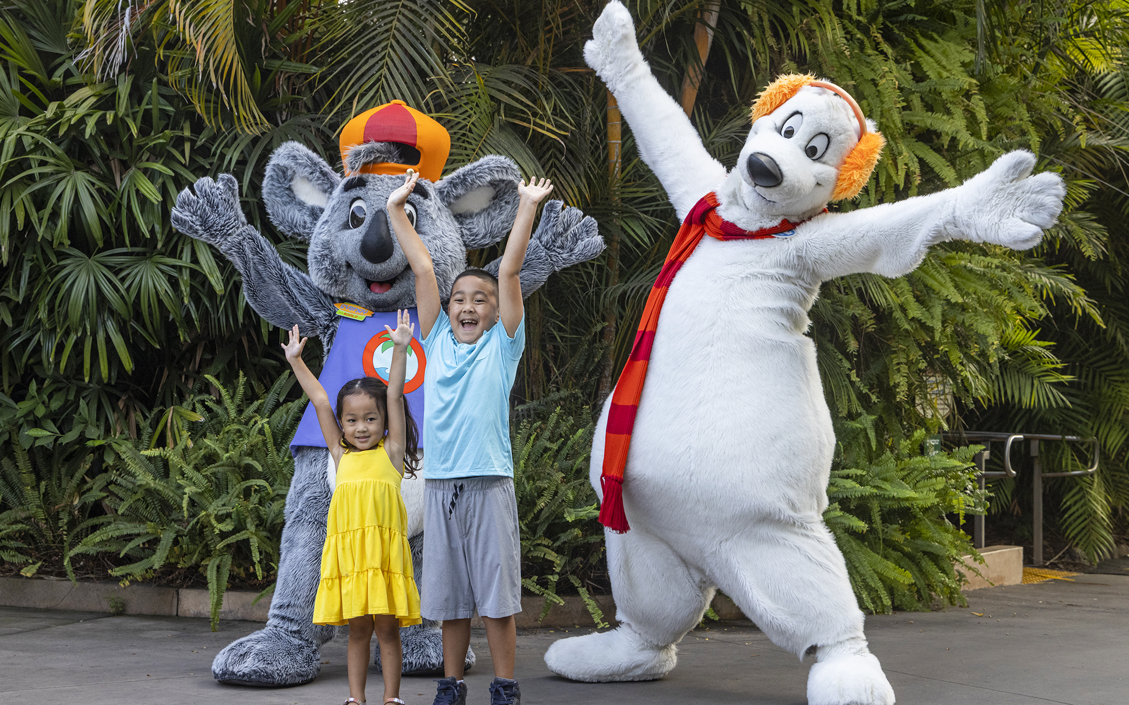 Children posing with animal mascots at San Diego Zoo.