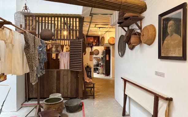 Interior of Chinatown Heritage Centre showcasing traditional household items and decor.