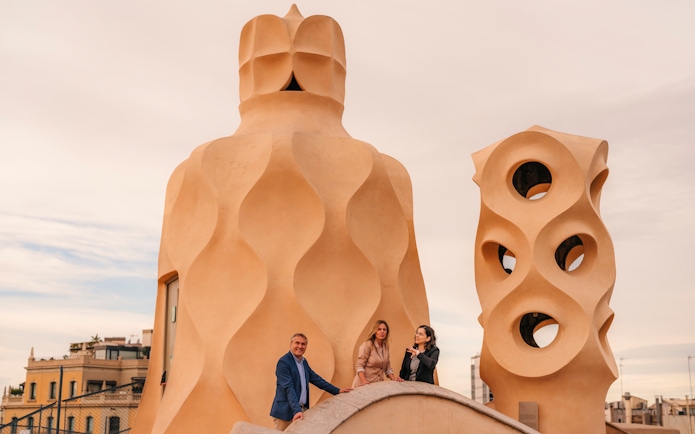 Tourists with guide exploring rooftop architecture at Casa Mila, Barcelona.