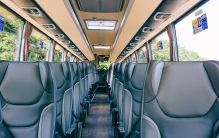 Interior of a tour bus with empty seats, en route to Windsor Castle from Central London.