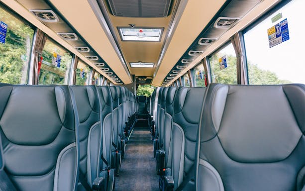 Interior of a tour bus with empty seats, en route to Windsor Castle from Central London.