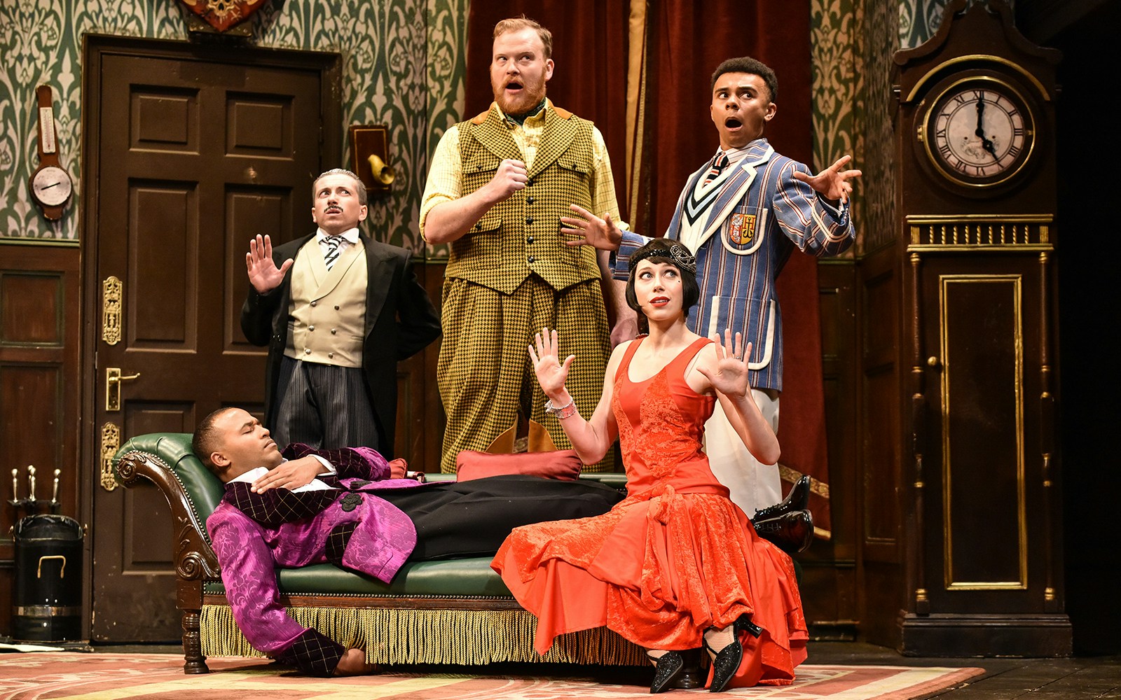Actors performing a comedic scene in "The Play That Goes Wrong" on stage.