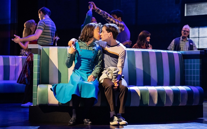 Couple kissing in a retro diner setting, inspired by Stranger Things.