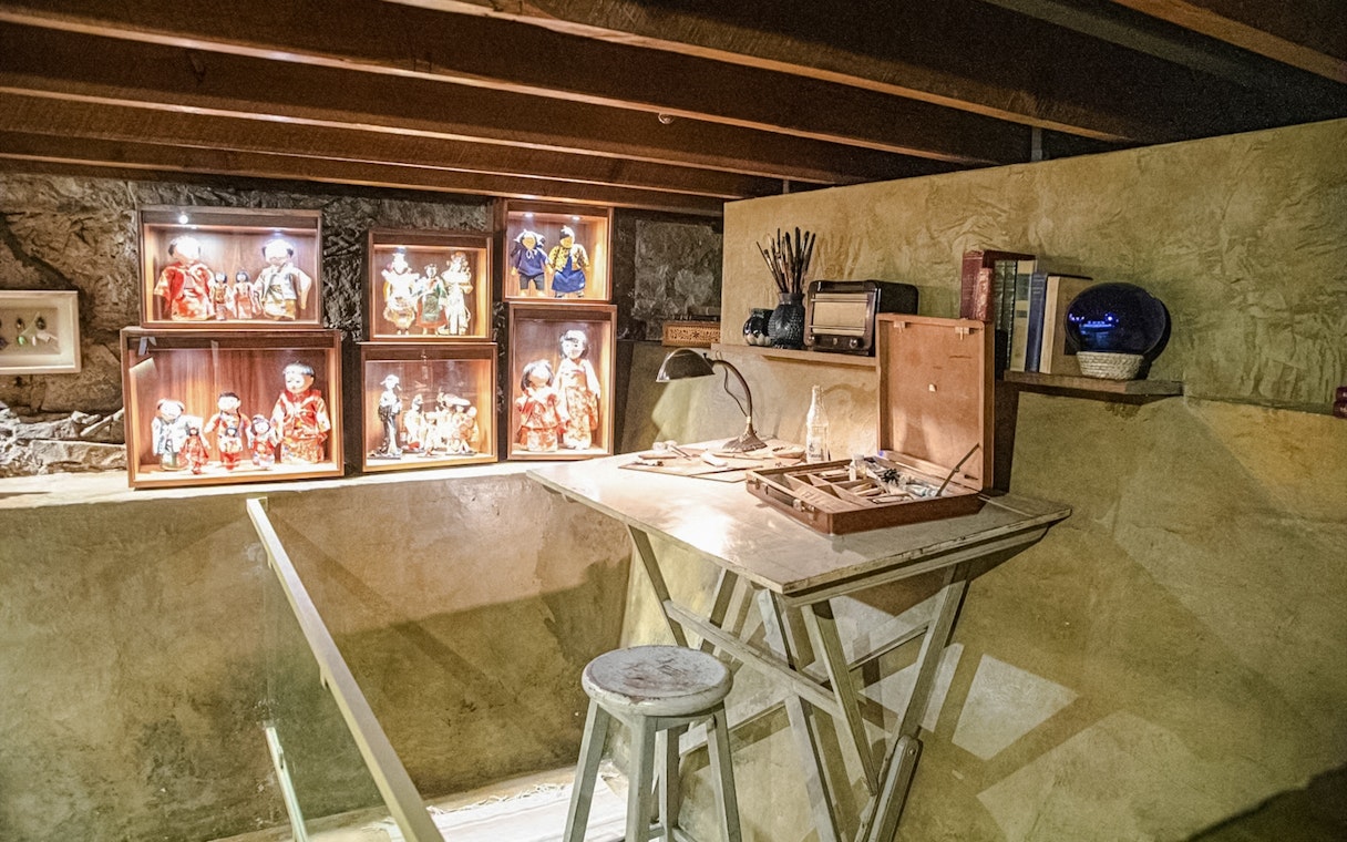 Basement studio with art supplies and doll displays in Museo Casa Kahlo, Mexico City.