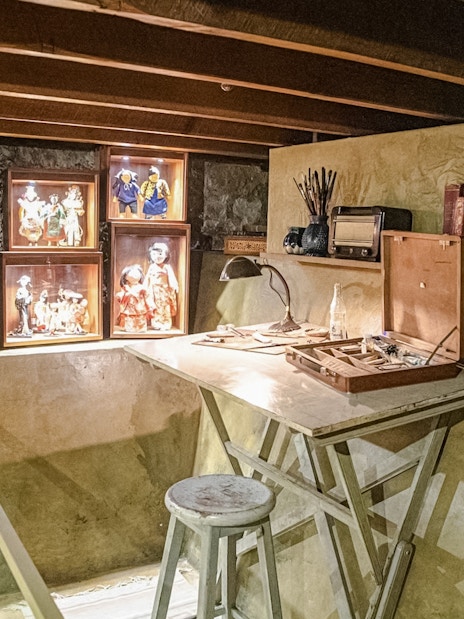 Basement studio with art supplies and doll displays in Museo Casa Kahlo, Mexico City.