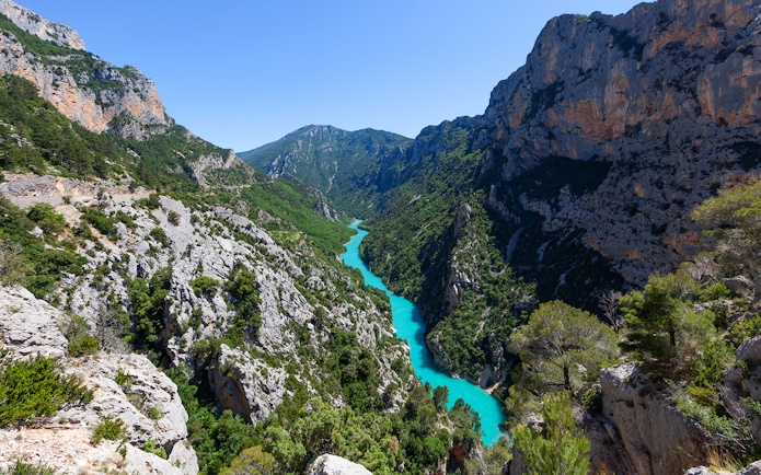 Verdon Gorge aerial view with turquoise river winding through rocky cliffs in Provence, France.