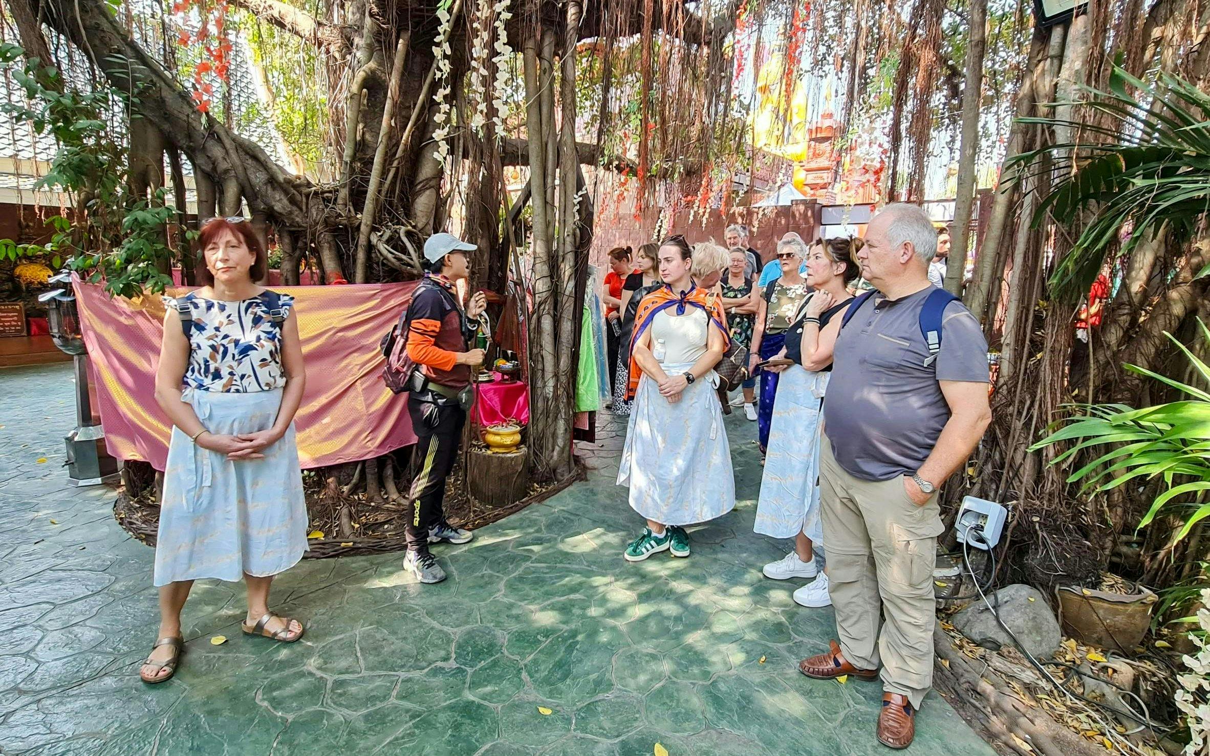 Tour group exploring a lush garden in Bangkok's Green Lung.