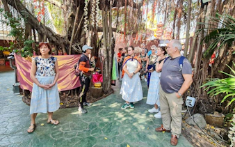 Tour group exploring a lush garden in Bangkok's Green Lung.