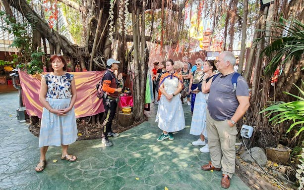 Tour group exploring a lush garden in Bangkok's Green Lung.